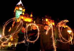 (left to right) Agustina Florio, Kathrin Ecke,Agustin Belloso and Tomas Espeche use sparklers to display the year 2016 as they get ready to celebrate the Hogmanay New Year celebrations in Edinburgh. PRESS ASSOCIATION Photo. Picture date: Thursday December 31, 2015. See PA story SOCIAL Hogmanay. Photo credit should read: Andrew Milligan/PA Wire