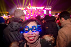 A Japanese tourist attends a New Year party on December 31, 2015 at the Brandenburg Gate in Berlin.   / AFP / dpa / Wolfram Kastl / Germany OUTWOLFRAM KASTL/AFP/Getty Images